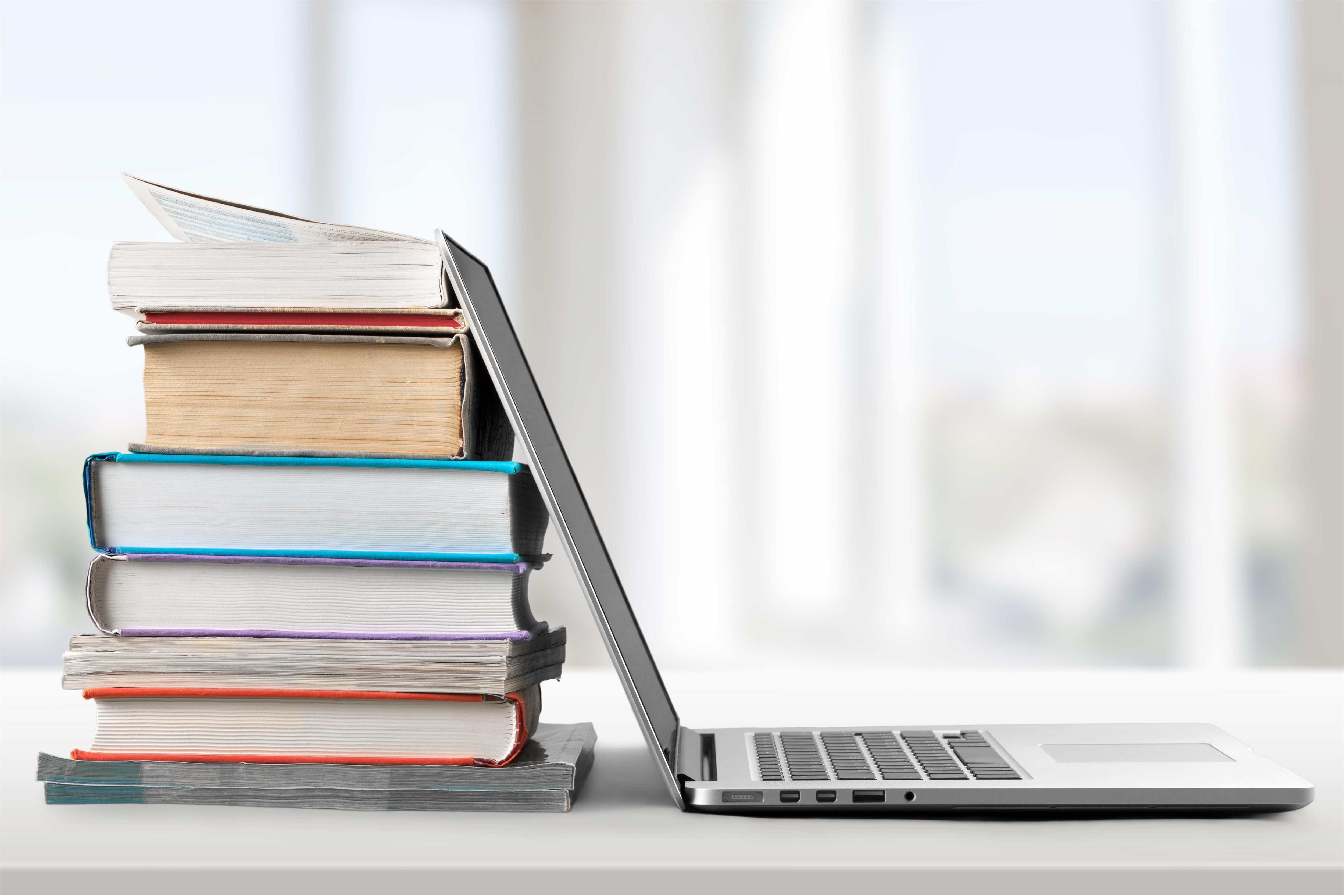 Laptop and stack of books